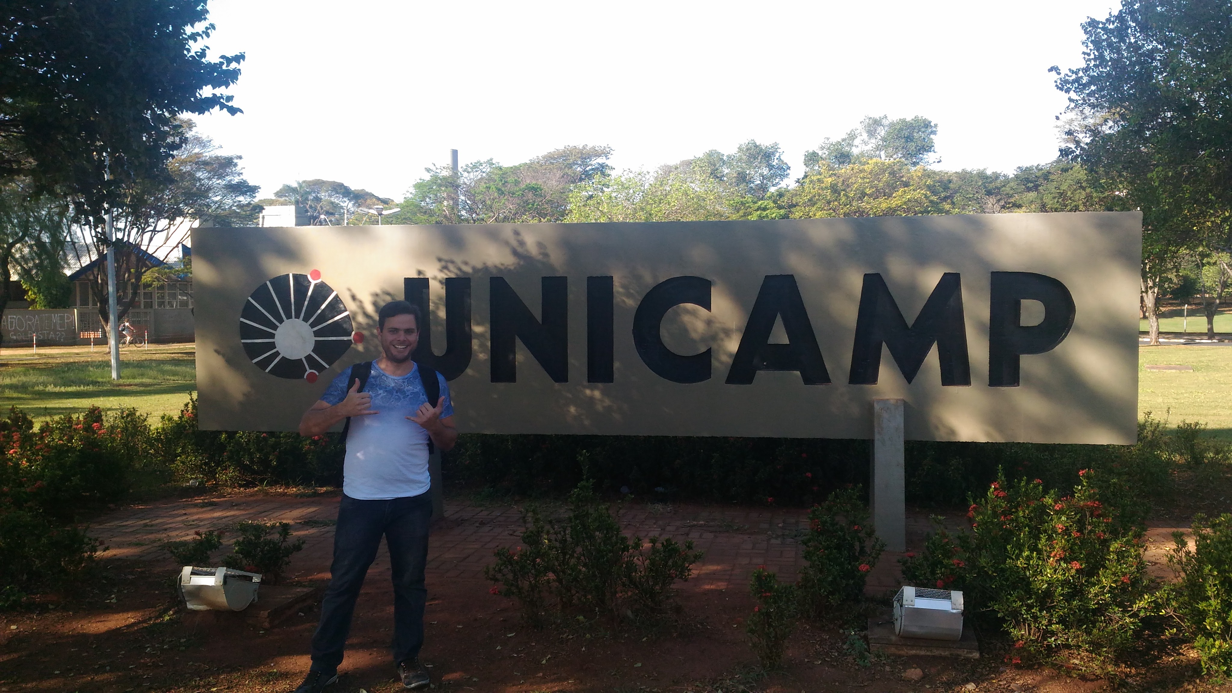 Fernando standing beside the UNICAMP campus sign